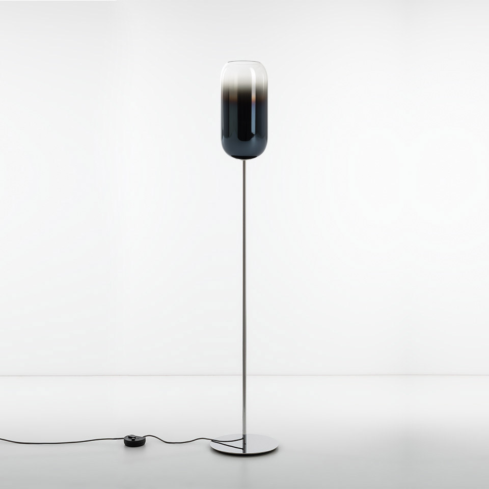 Artemide Gople floor lamp with elongated capsule-shaped blue-grey glass diffuser on a slim chrome stem and round base