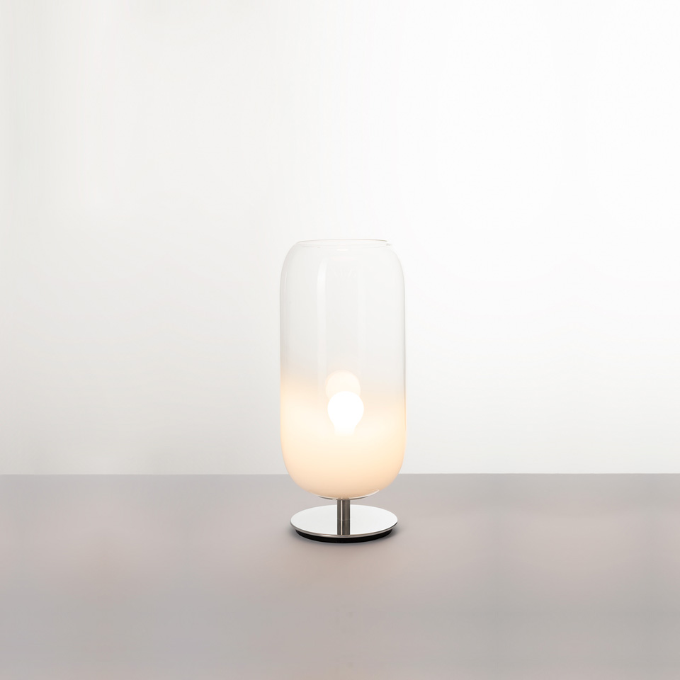 Artemide Gople table lamp: tall capsule-shaped blown glass shade, clear top fading to white, on a polished chrome base