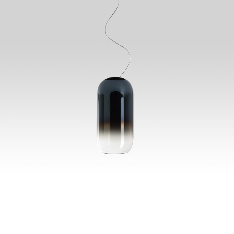 Artemide Gople pendant lamp: pill-shaped blown glass shade with dark blue-to-clear gradient, suspended by thin cable