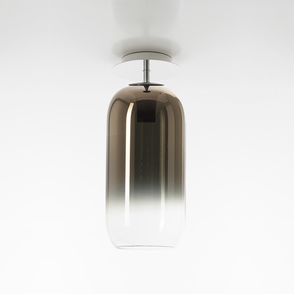 Artemide Gople ceiling lamp with elongated capsule-shaped smoked glass diffuser, gradient from bronze top to clear bottom, chrome fitting