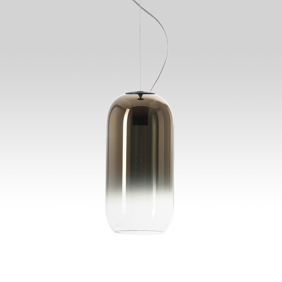 Artemide Gople pendant lamp: capsule-shaped blown glass shade with bronze-to-clear gradient, suspended by a thin steel cable