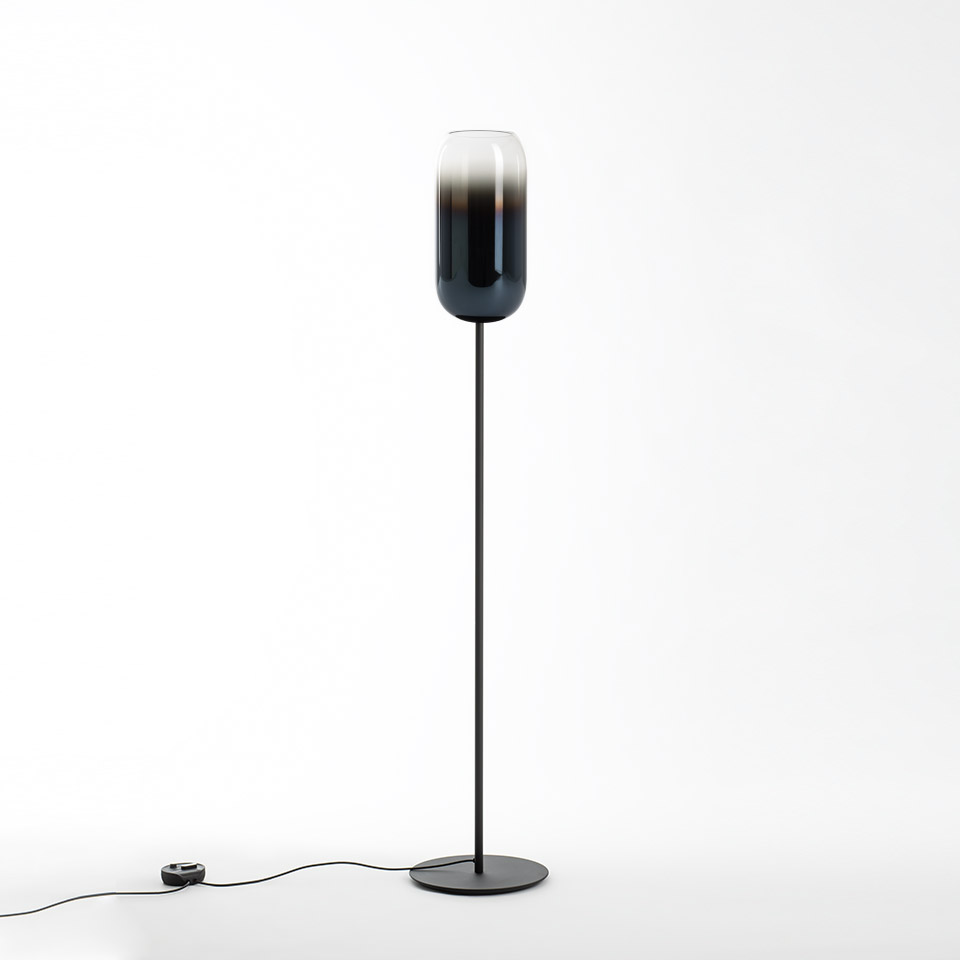 Artemide Gople floor lamp with elongated capsule-shaped glass shade, dark blue gradient, on slim black metal stem and round base