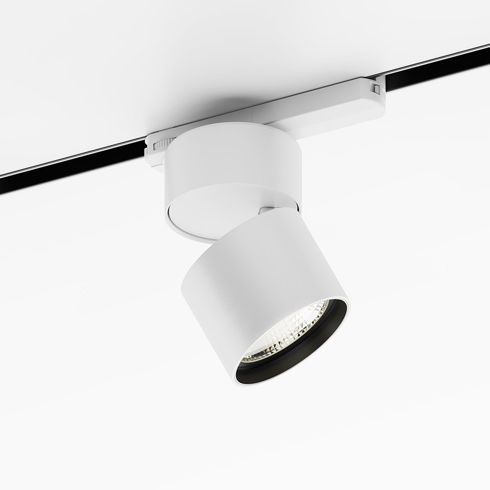 Artemide Hoy Spot su binario trifase: faretto LED cilindrico bianco con testa orientabile, montato su sistema a binario nero