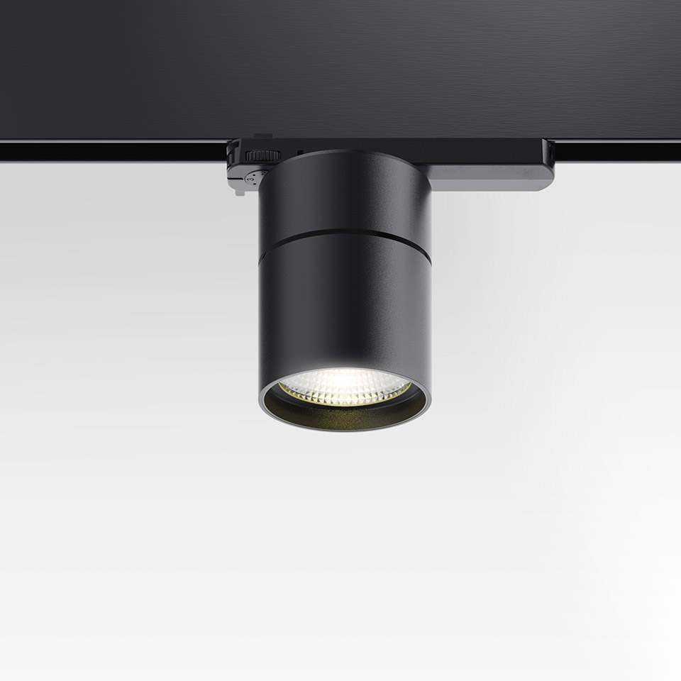 Artemide Hoy Spot 3-Phase Track: faretti LED cilindrici neri montati su binario nero, con luce bianca calda verso il basso - 2