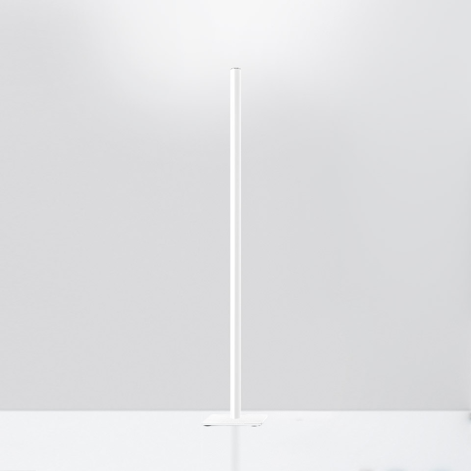 Artemide Ilio floor lamp: minimalist white slender vertical stem with circular base, emitting invisible upward LED light