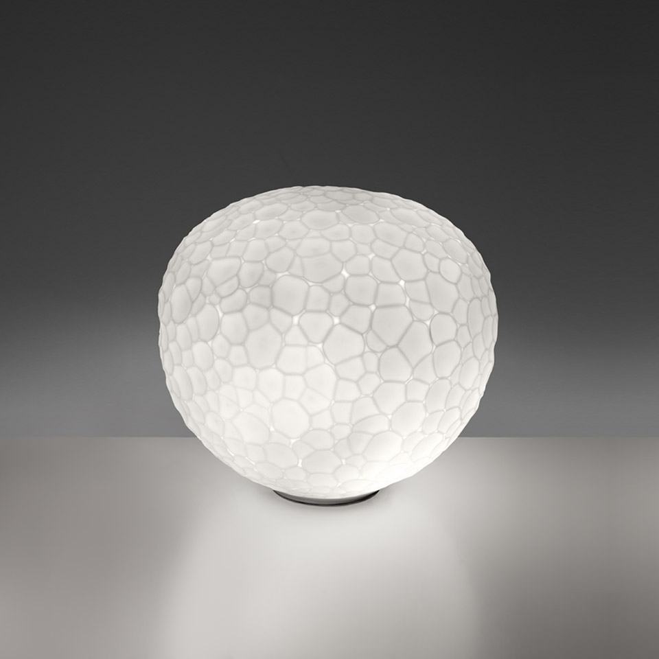 Artemide Meteorite Tavolo table lamp: opal white blown glass globe with organic cellular texture on a small dark base