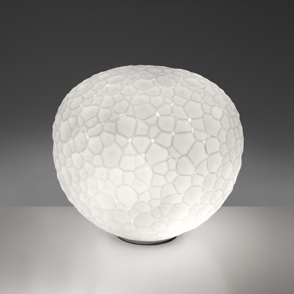 Artemide Meteorite Tavolo table lamp: opal white blown glass globe with organic cellular texture on a small dark base