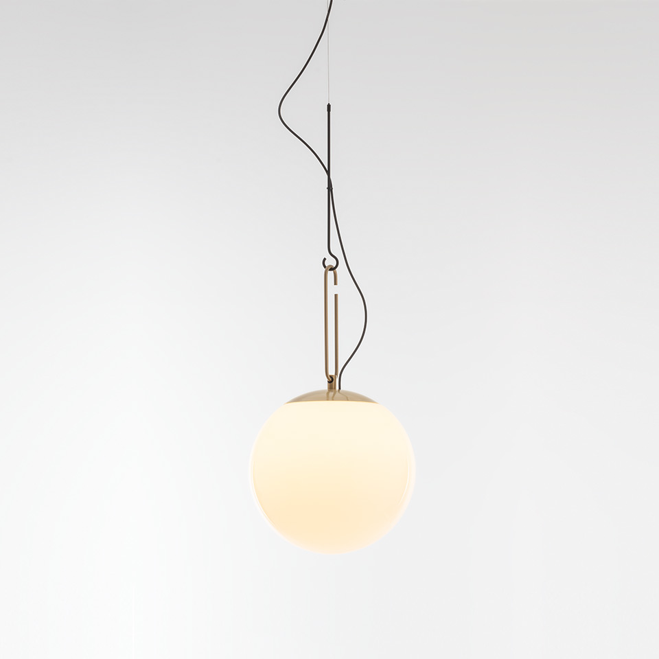 Artemide NH pendant lamp: opal white glass sphere suspended by brass rod and black cable on a minimalist ceiling mount