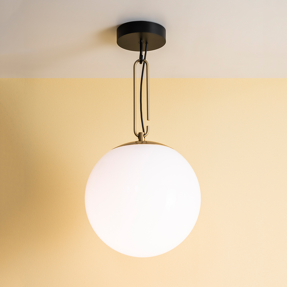 Artemide NH pendant lamp with opal white spherical glass globe, brass chain, and black ceiling canopy