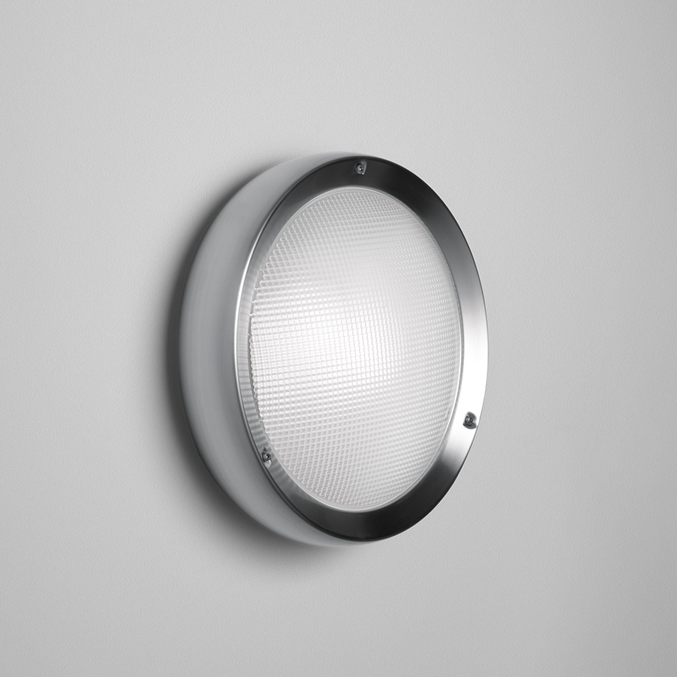 Lampada da parete/soffitto Artemide Niki: apparecchio rotondo con anello in acciaio spazzolato e diffusore prismatico bianco, montato a parete