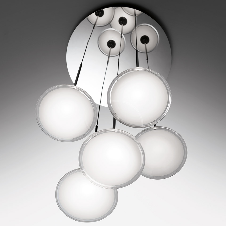 Artemide Orsa Cluster pendant: six white opal disc-shaped diffusers with transparent rims suspended on black cables from a round chrome ceiling plate