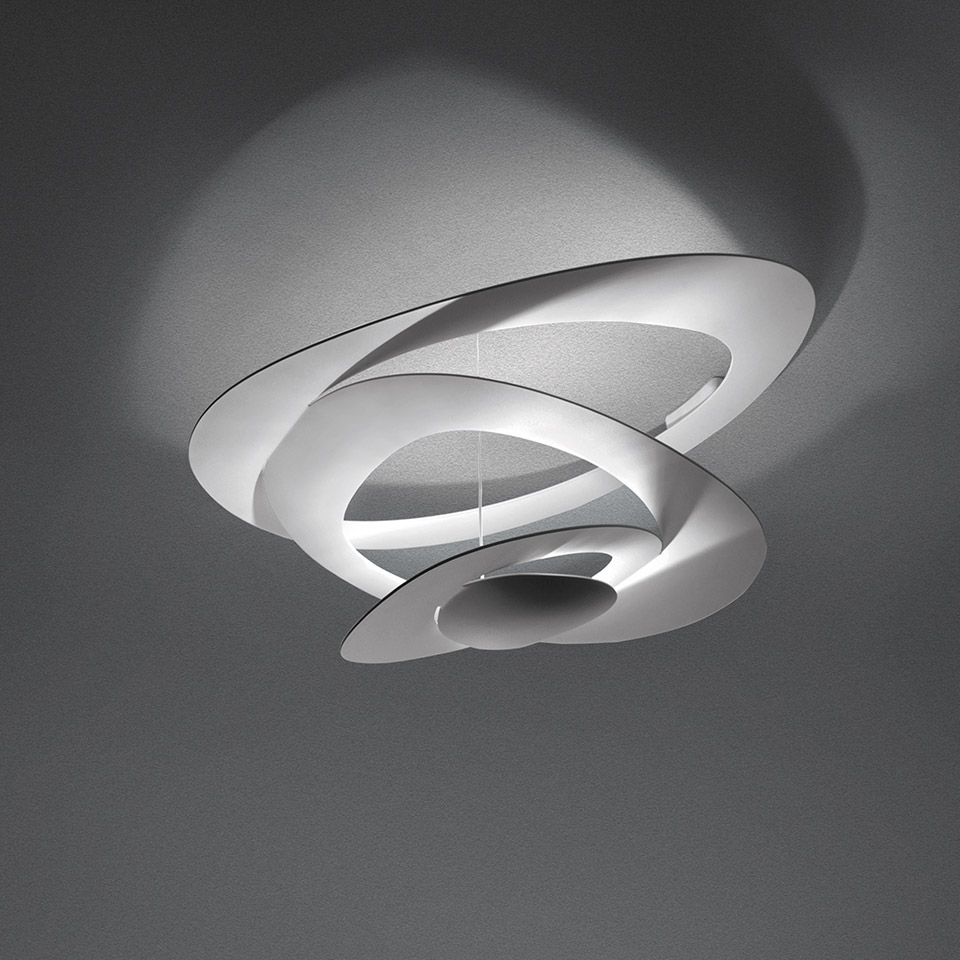 Artemide Pirce Soffitto ceiling lamp in white, featuring a sculptural spiral design with layered curved blades casting dramatic shadows
