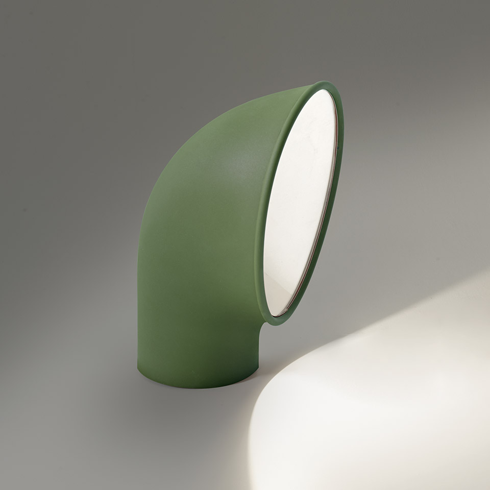 Artemide Piroscafo table lamp in sage green, curved tubular body with angled white diffuser emitting warm directional light