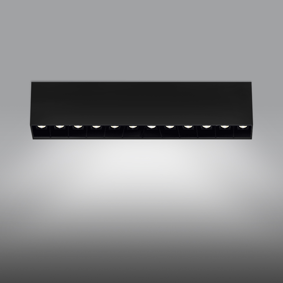 Artemide Sharp SMD ceiling light, black rectangular housing with 10 recessed LED spots casting a wide, uniform beam downward