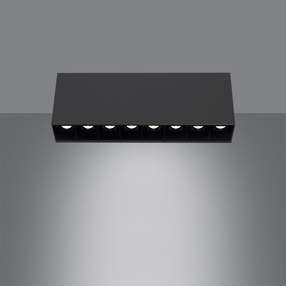 Artemide Sharp SMD ceiling light, black rectangular fixture with six downward-facing LED spots casting a focused white light beam