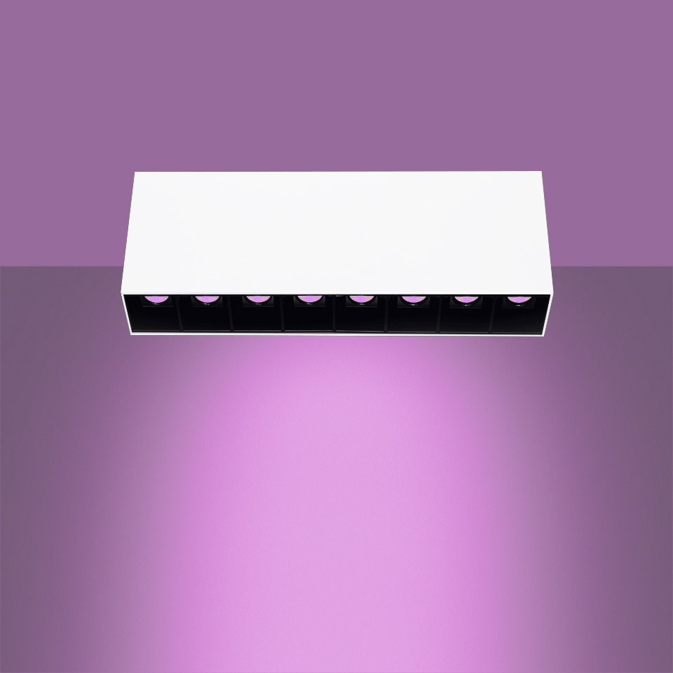 Artemide Sharp SMD ceiling light, white rectangular body with 8 black-cell LED modules emitting vibrant purple light downward