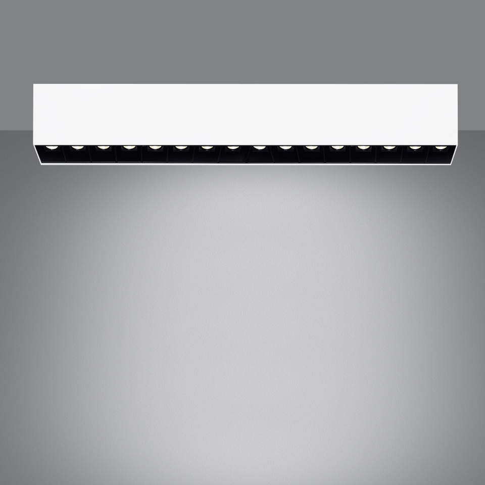 Artemide Sharp SMD ceiling light: white rectangular housing with a row of black recessed LED spotlights casting a wide downward beam