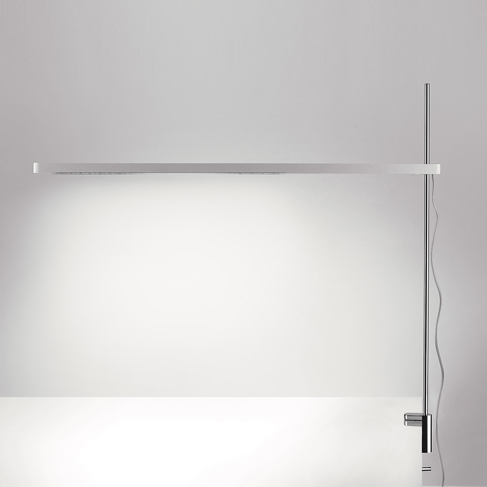 Artemide Talak Professional Table lamp: slim horizontal LED bar on chrome clamp pole, casting wide uniform light downward