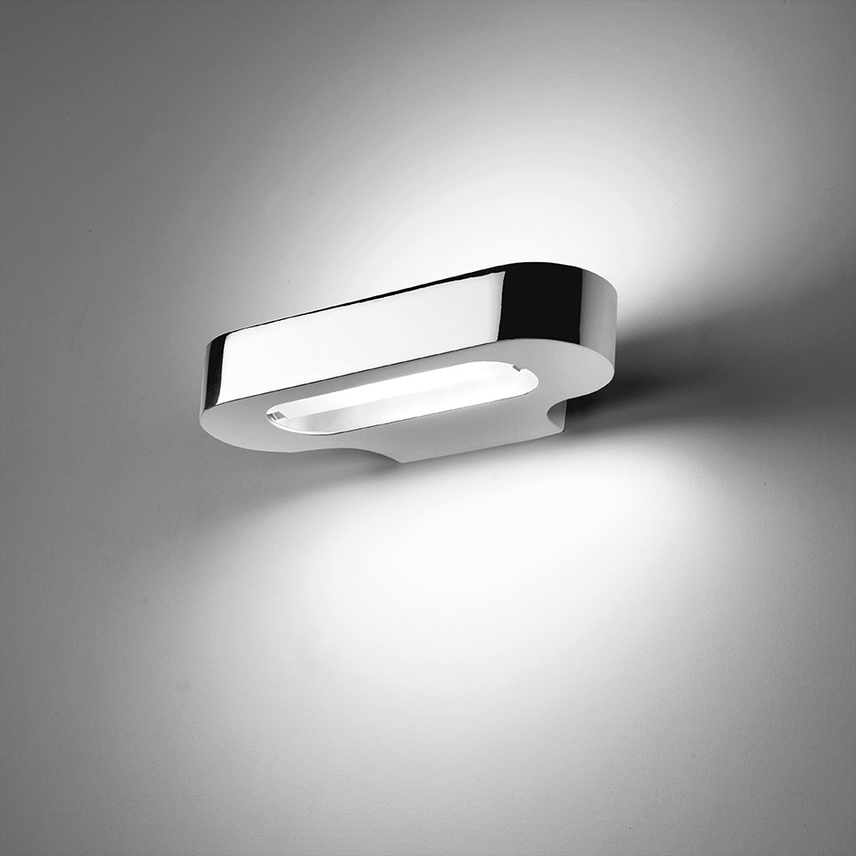 Artemide Talo wall lamp in polished chrome, oval shape emitting upward and downward light beams against a grey wall