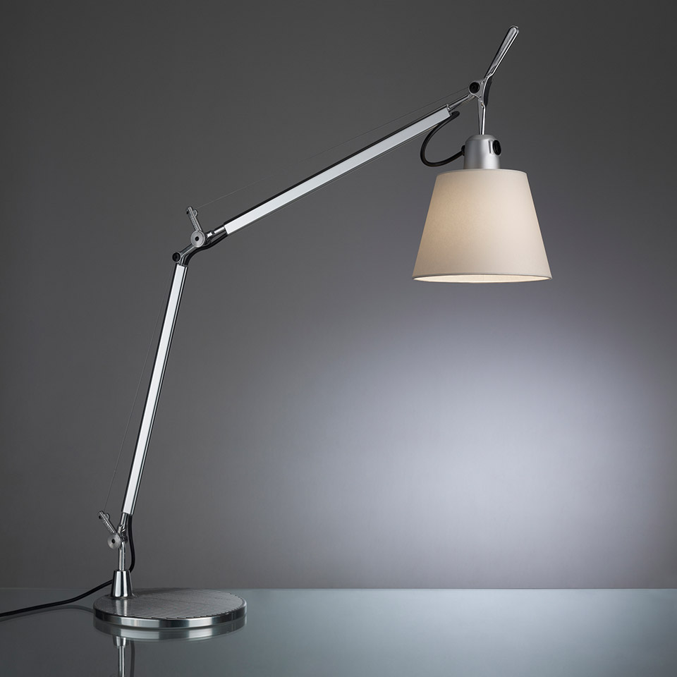 Artemide Tolomeo Basculante table lamp with adjustable aluminum arm, conical parchment shade, and circular weighted base