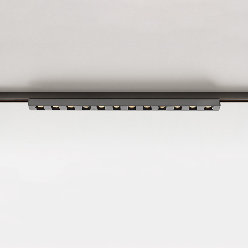 Artemide Turn Around System: elegante barra LED lineare nera con 12 faretti orientabili montata su binario a soffitto