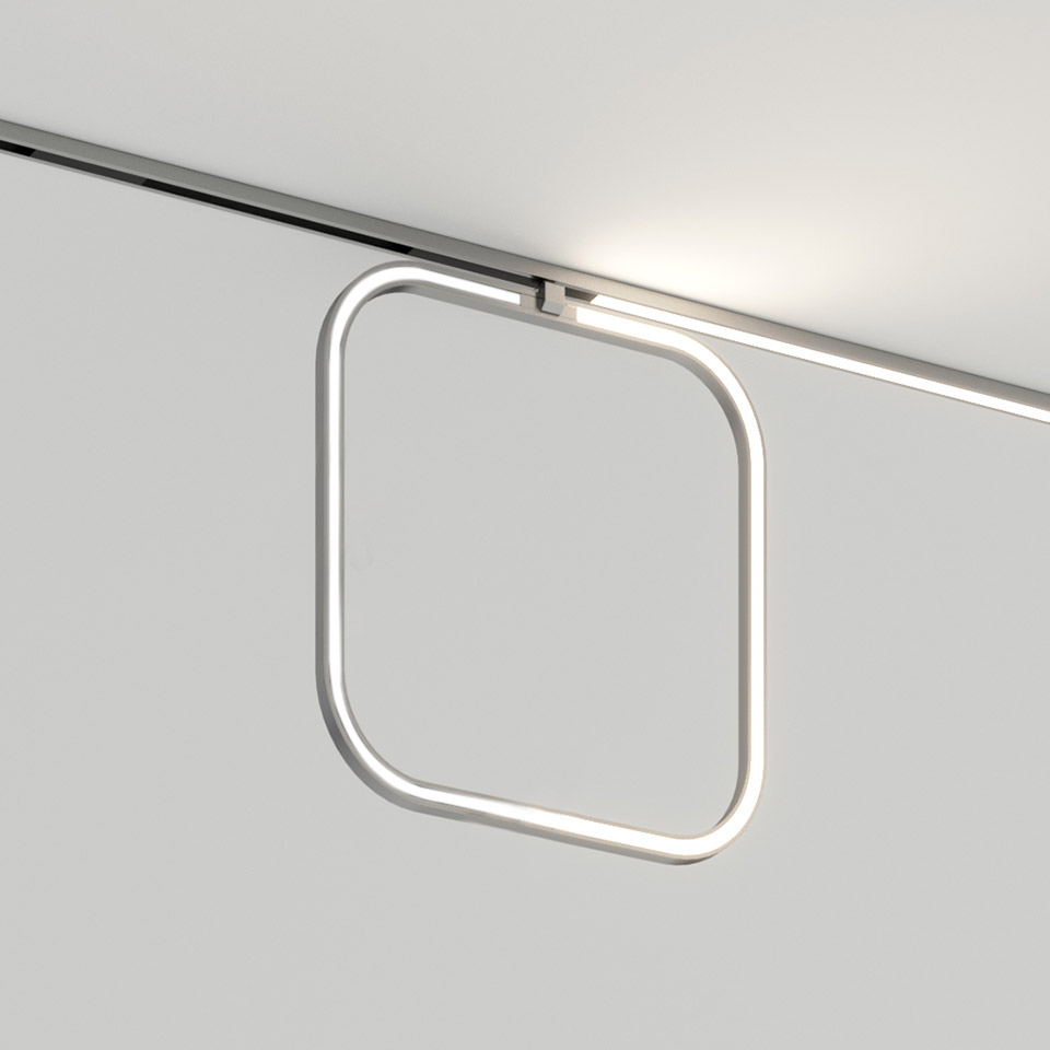 Artemide Turn Around System: anello LED quadrato con angoli arrotondati montato su binario a soffitto, che emette luce bianca diffusa
