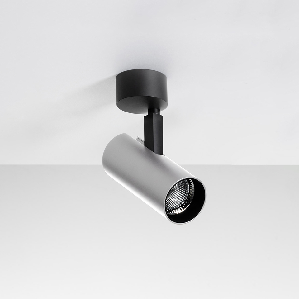Artemide Vector Ceiling spotlight: adjustable silver cylindrical head with LED lens on black stem and ceiling mount