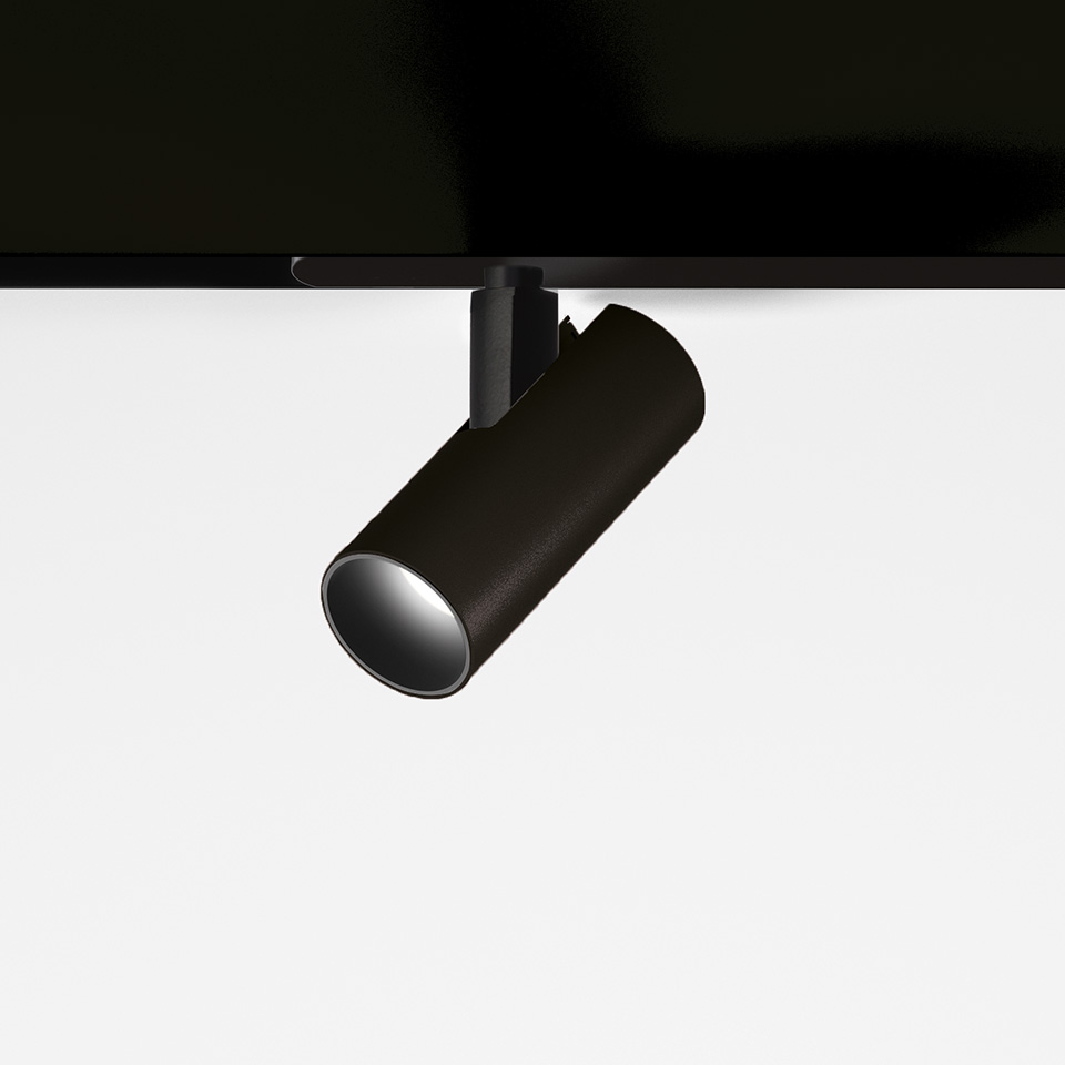 Faretto da binario magnetico Artemide Vector Magnetic nero opaco, corpo cilindrico inclinato su supporto a binario magnetico, LED direzionale.