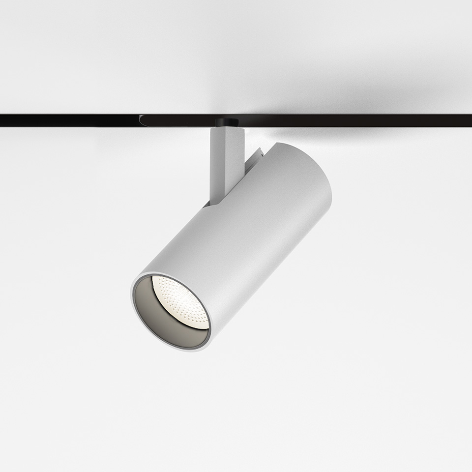 Faretto da binario magnetico Artemide Vector Magnetic bianco, corpo cilindrico su binario magnetico nero, testa LED direzionale orientabile