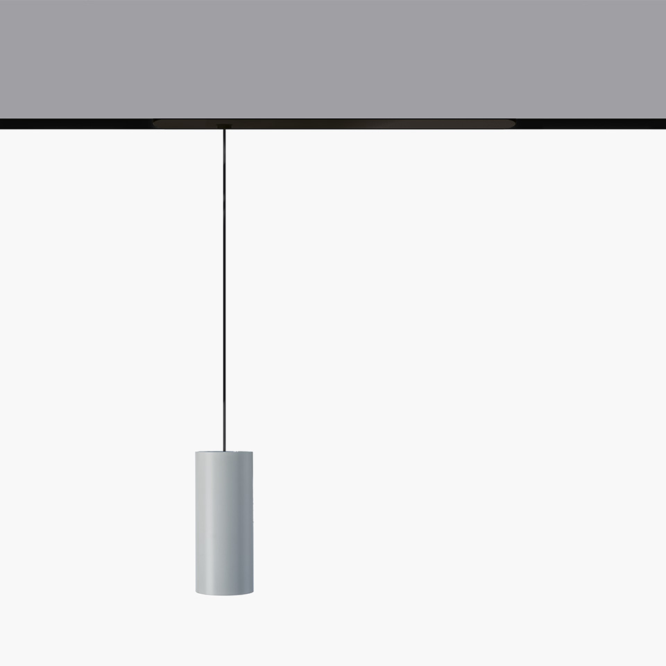 Artemide Vector Pendant Magnetic: cylindrical gray pendant lamp suspended by a black cable from a magnetic track system