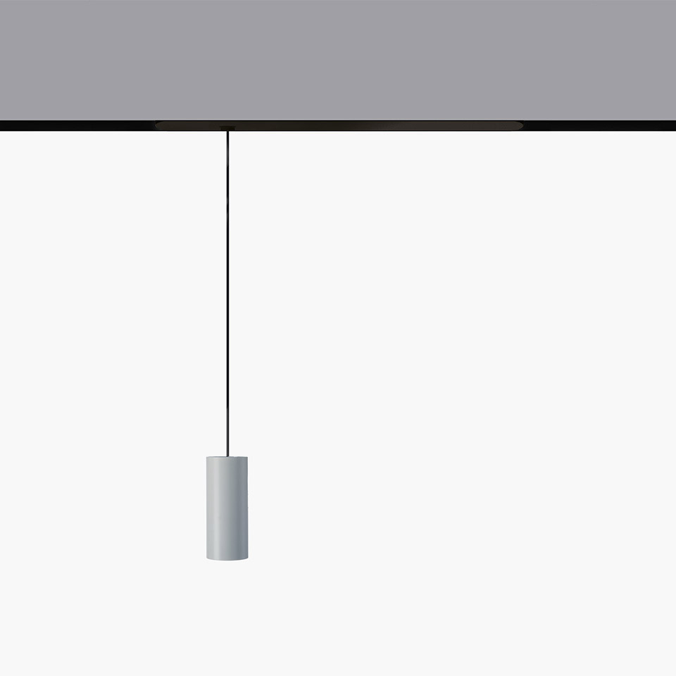 Artemide Vector Pendant Magnetic: cylindrical gray pendant lamp hanging from a black magnetic track via a thin black cable