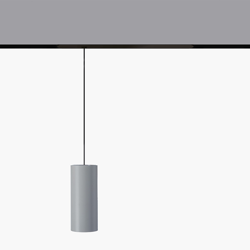 Artemide Vector Pendant Magnetic: cylindrical gray pendant lamp hanging from a black magnetic track via a thin black cable