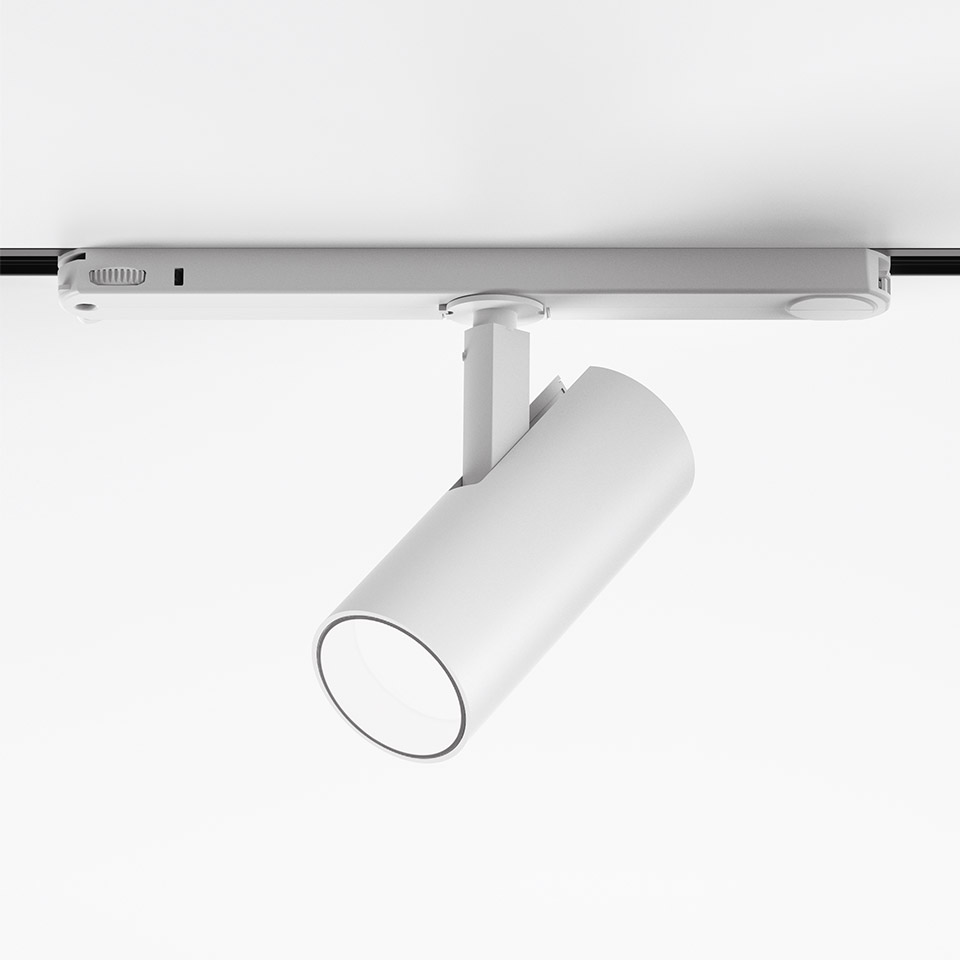 Artemide Vector Track 230V: faretti LED cilindrici bianchi montati su binario, con inclinazione regolabile per illuminazione direzionale