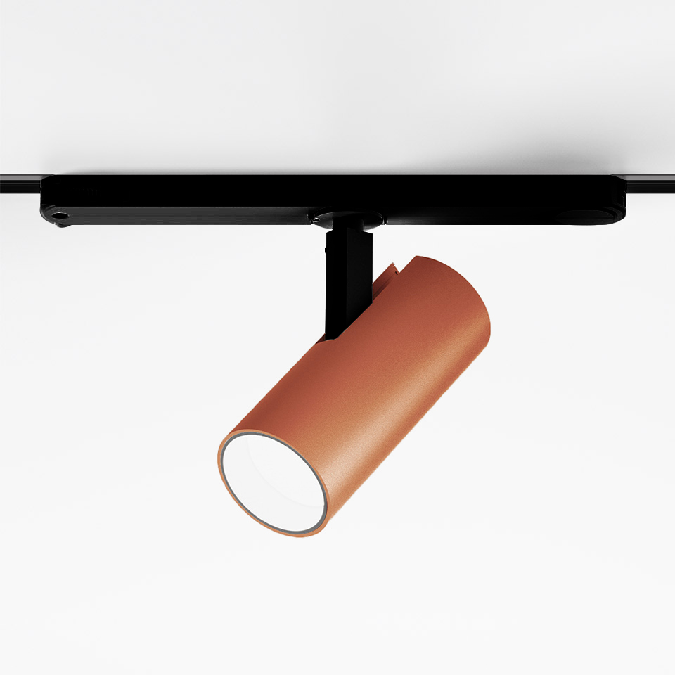 Faretto Artemide Vector Track 230V: testa cilindrica color terracotta su binario nero, apparecchio LED direzionale orientabile