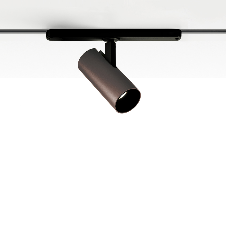 Artemide Vector Track 230V: faretto cilindrico orientabile color bronzo montato su binario nero