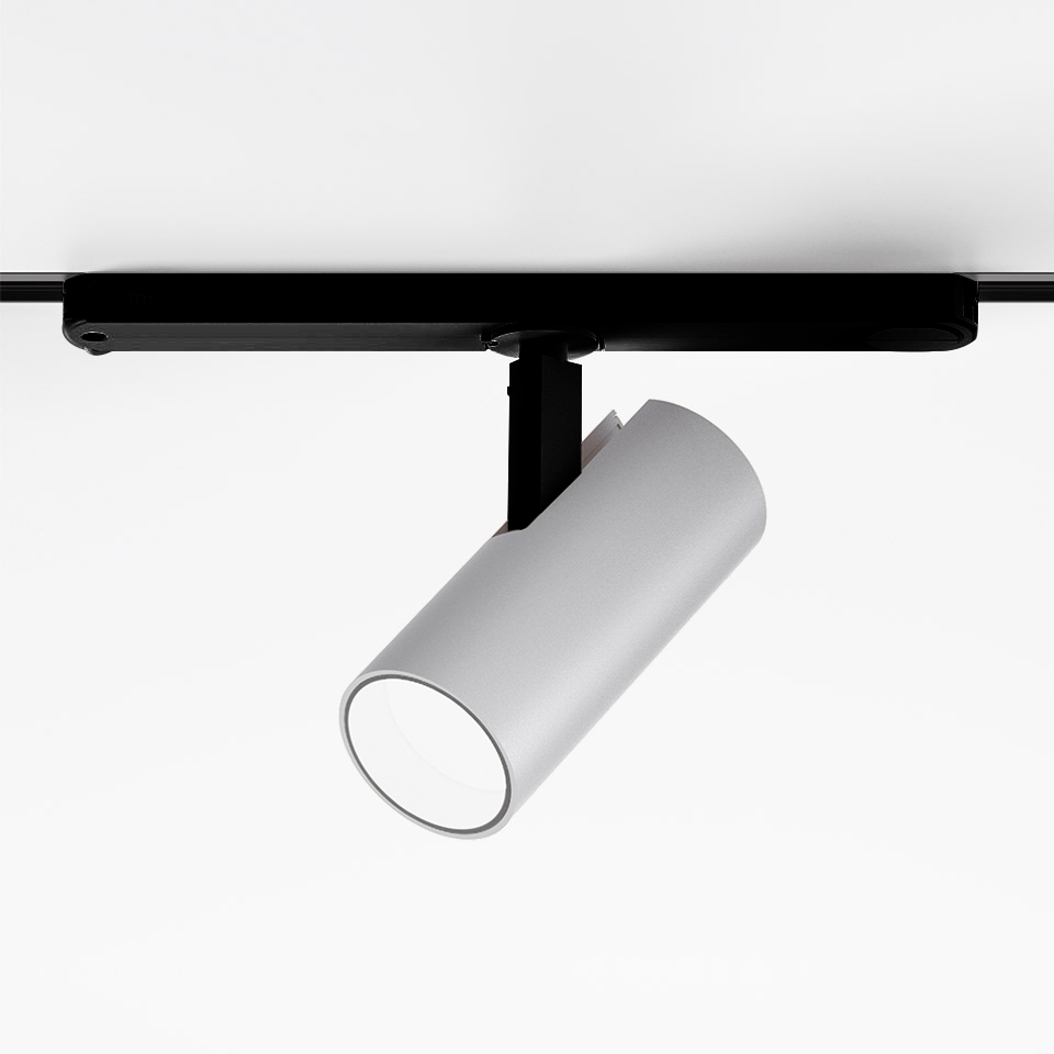 Artemide Vector Track 230V: faretto cilindrico bianco orientabile montato su binario nero, inclinato verso il basso
