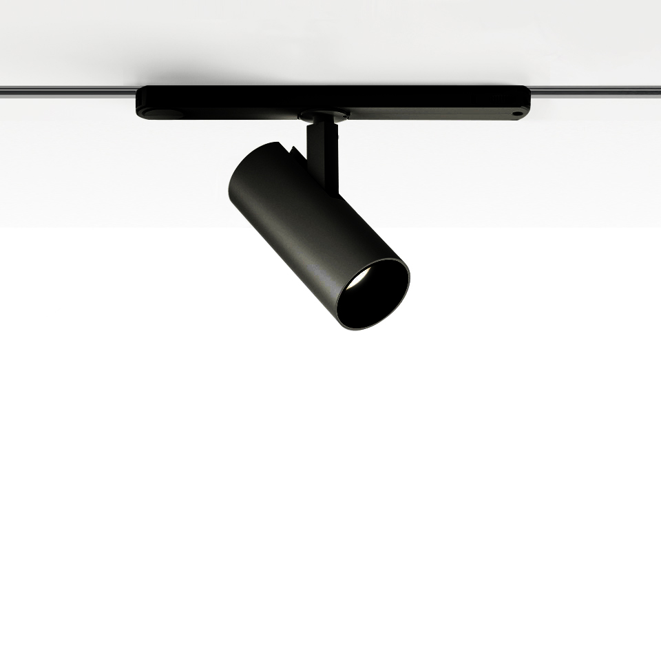 Artemide Vector Track 230V: faretto cilindrico nero orientabile montato su binario a soffitto, inclinato