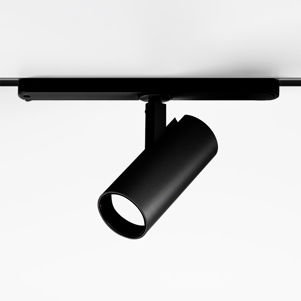 Faretto nero Artemide Vector Track 230V su binario, corpo cilindrico, inclinazione regolabile, emette luce bianca concentrata verso il basso