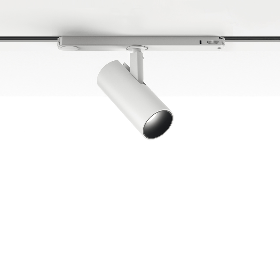 Artemide Vector Track 230V: faretto cilindrico bianco orientabile montato su binario a soffitto, inclinato