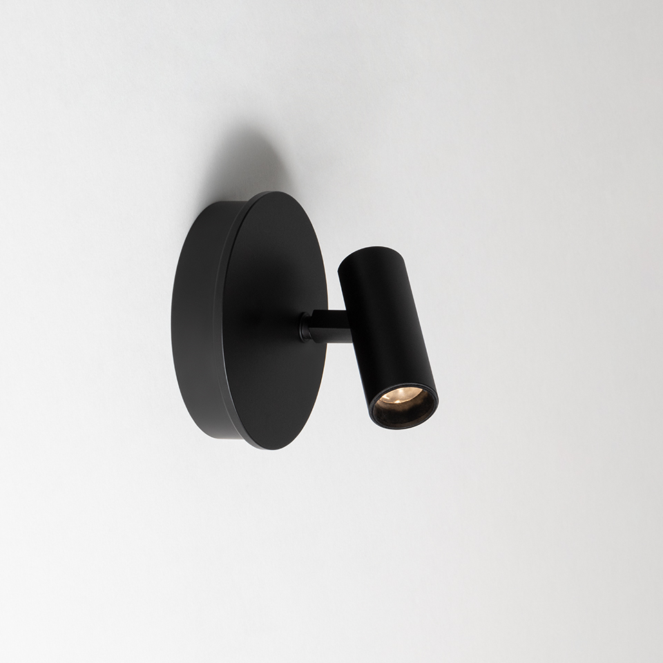 Artemide Vector Wall spotlight in matte black, circular wall base with adjustable cylindrical arm and directional LED head