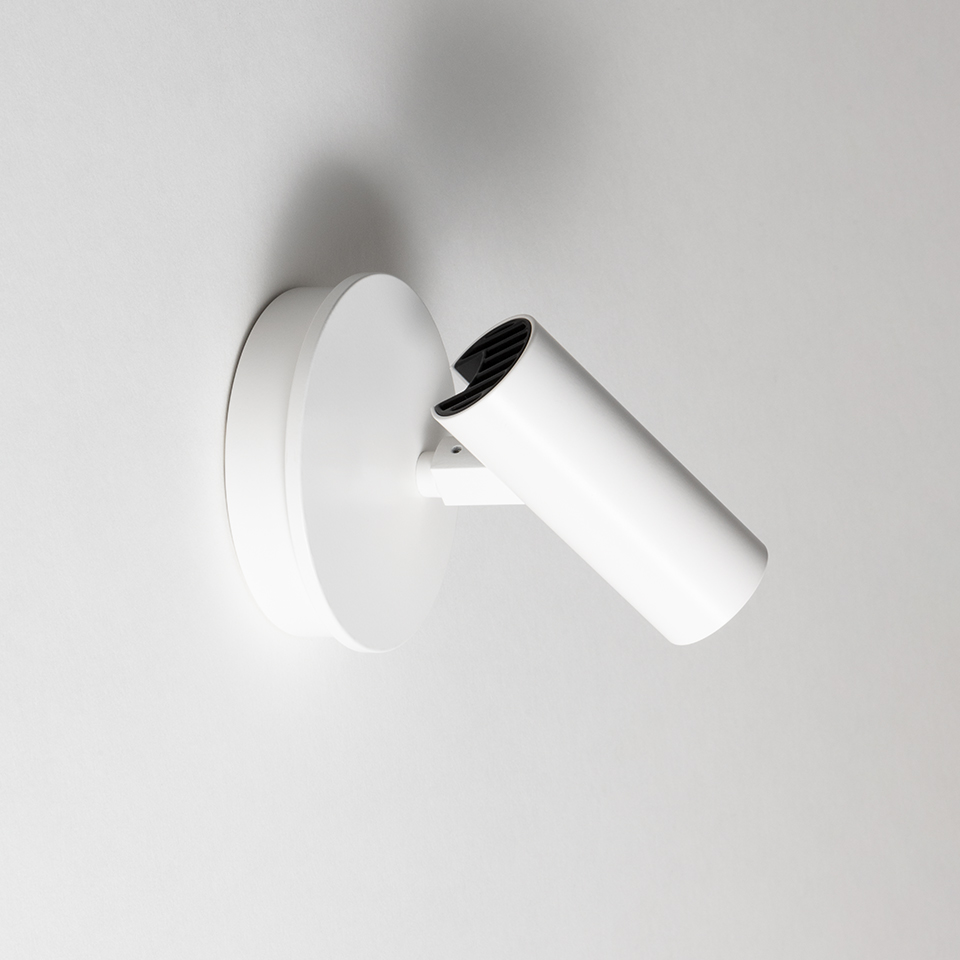 Artemide Vector Wall spotlight in white, cylindrical adjustable head with anti-glare louvre, mounted on round wall base