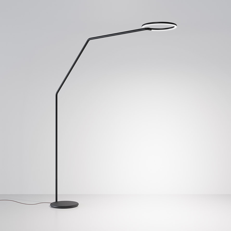 Artemide Vine Light floor lamp in black, featuring a slender angular arm and circular LED ring head on a round base