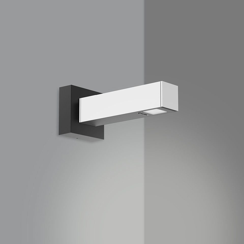 Artemide Walking Parete wall lamp: white rectangular LED bar on dark bracket, mounted at room corner, emitting directional light