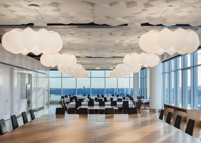 Elegant restaurant with Artemide cloud-shaped white pendant lamps floating above dining tables, floor-to-ceiling windows with city view