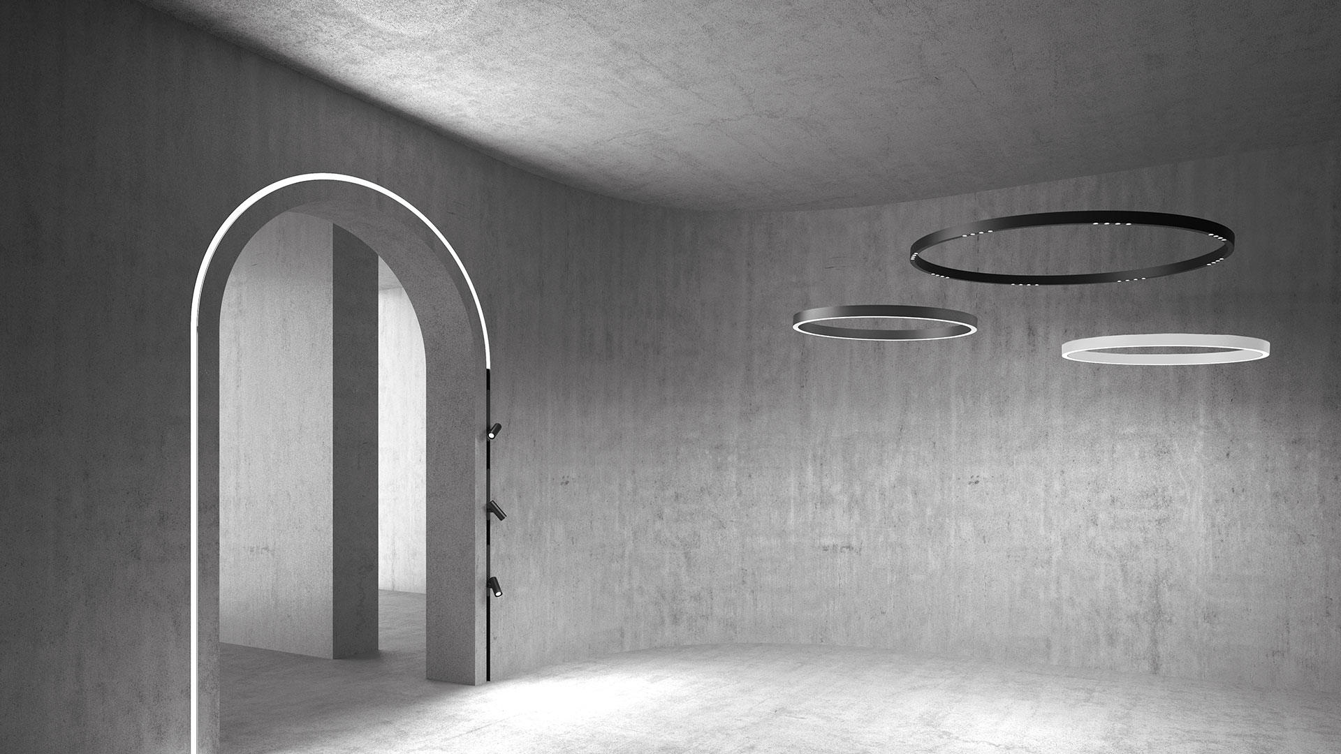 Minimalist concrete room with Artemide A.24 circular pendant lights in black and white, alongside an arched doorway outlined with linear LED light.
