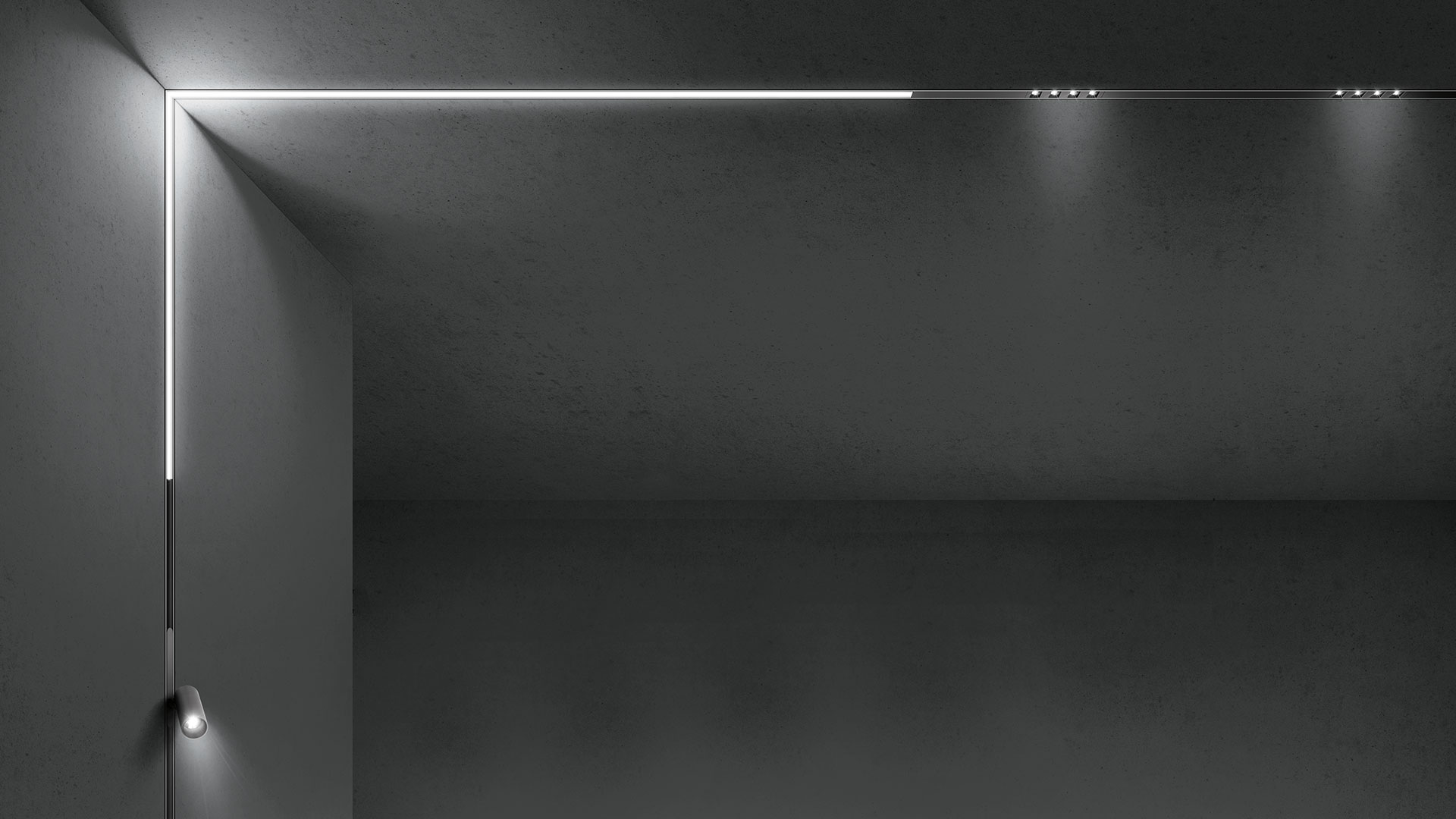 Artemide A.24 system: black ceiling track with spotlights, pendant cylinders, and A.24 Emissione linear wall lights emitting soft horizontal light