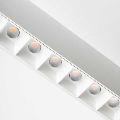 Artemide A.39 ceiling light with a row of six recessed LED spotlights in white housing, featuring warm-toned refractive lenses