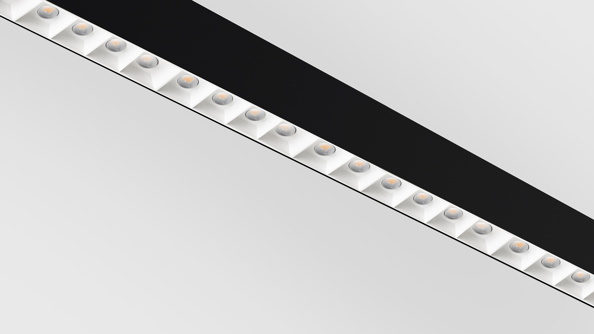 Plafoniera Artemide A.39: struttura lineare bianca con cinque moduli LED a lente refrattiva che emettono luce calda