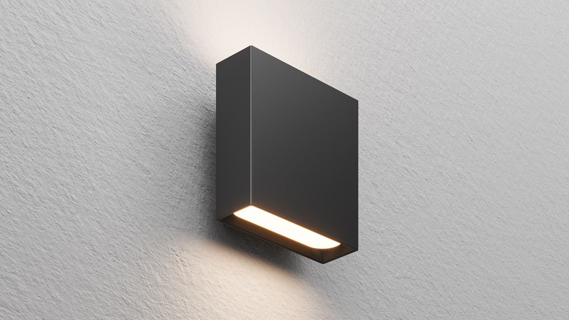 Applique Artemide Agathe: corpo rettangolare antracite scuro montato su parete bianca, emette luce bianca calda verso il basso attraverso una fessura orizzontale.