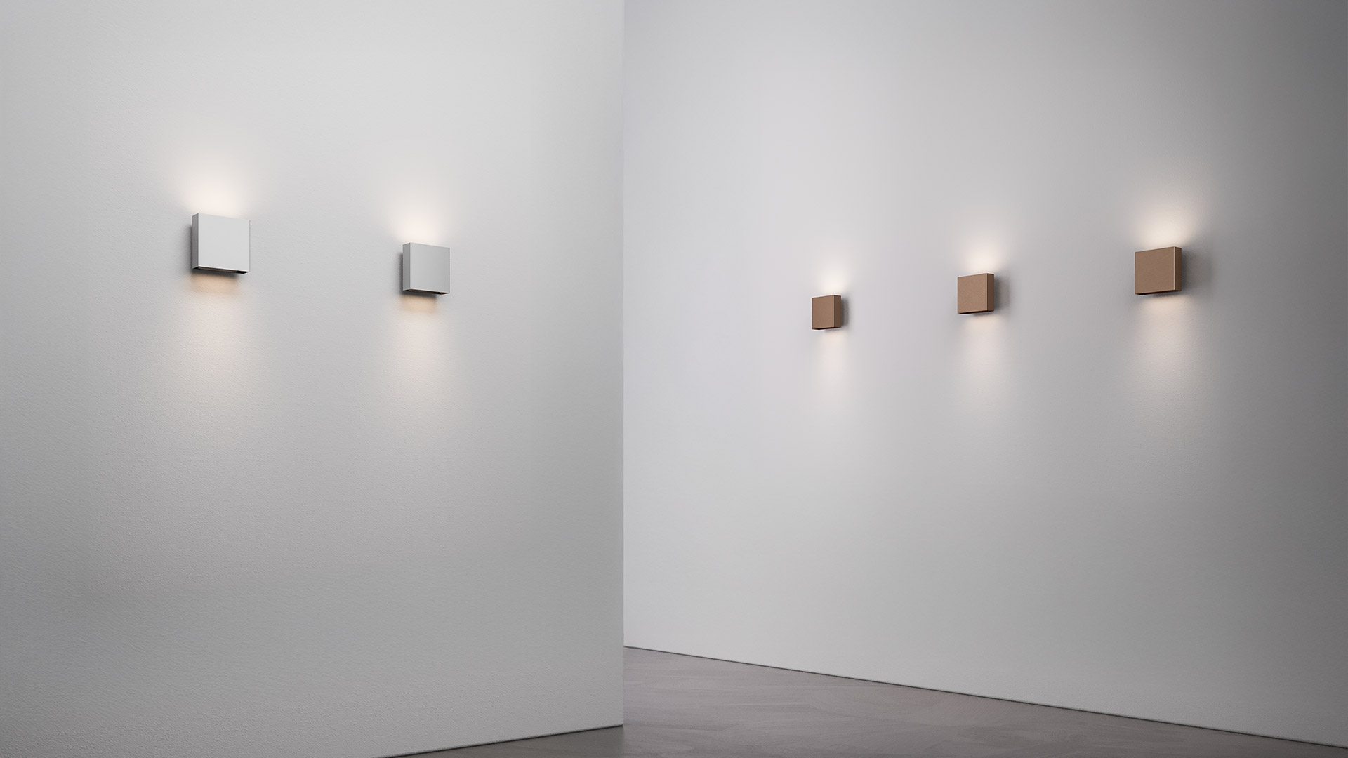 Cinque applique Artemide Agathe in fila, con luce calda verso il basso, nelle finiture bianco, grigio chiaro, rame, bronzo e grigio scuro